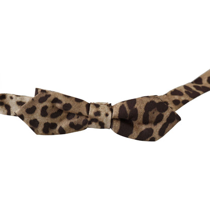 Dolce & Gabbana brown leopard silk bow tie with adjustable neck strap, made in Italy, displayed flat on a white background.