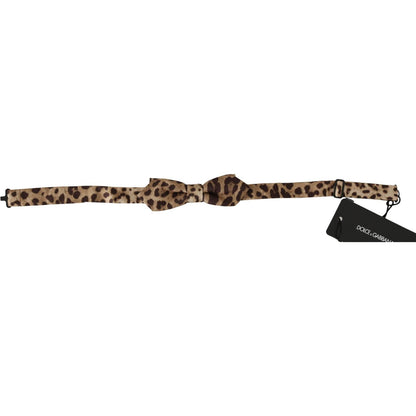 Dolce & Gabbana brown leopard silk bow tie with adjustable neck strap, made in Italy. Luxurious men's fashion accessory.
